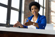 © wavebreak3 - Mid adult african american woman gesturing and explaining at office desk with tablet
