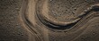 © MetaPixel - Panoramic perspective of gravel road from above showing tire marks