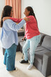 © DisobeyArt - African american daughter helping her mother to wear a foot brace after a injury - Medical, insurance and healthcare concept - Main focus on girl face