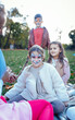 © Zoran Zeremski - Female animator painting a child's face with a brush at an outdoor birthday party in a park.