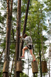 © Virsis - Active Boy Overcoming Rope Course Obstacles in Adventure Park