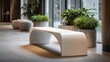 © Newleks - White curvilinear bench furnishing a minimalist modern office lobby, creating a calming waiting area ambiance with potted green plants and natural light