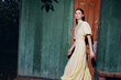 © SHOTPRIME STUDIO - woman portrait fashion dress walking by wooden door in sunlight vintage photography with authenticity inclusivity casual pose