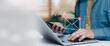 © ภัทรชัย รัตนชัยวงค์ - Business professional working on laptop and smartphone with virtual email notification icons, concept of inbox email marketing, online communication, digital workflow and modern business technology.
