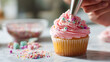 © Valto Photo - Pink Cupcake with Colorful Sprinkles Decorated by Pastry Chef in Bakery