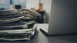© sebra - A pile of papers next to the laptop