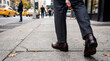 © anasa - Walking Out of Frame on City Sidewalk