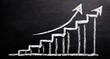 © Moritz - Hand-drawn chalk arrow on a blackboard in the shape of stairs symbolizing a successful path and business progress