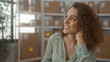 © Krakenimages.com - Young hispanic woman with hand on chin beside stacked parcel boxes on metal shelving in building; thoughtful planning.