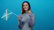 © Krakenimages.com - Woman holding scottish flag with red hair gestures no against blue background, conveying caution with finger expression.