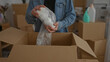 © Krakenimages.com - Man packing in new home holding bubble wrap and cardboard box in modern room suggesting moving into apartment with organized items and preparation for settling.