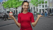 © Krakenimages.com - Woman holding icecream cup with strawberries and cream, hand palm up presenting and smiling on a street;summer joy.
