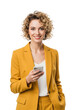 © Hannelore - young caucasian businesswoman in a tailored yellow power suit holding a modern smartphone, smiling confidently against a transparent high-key studio backdrop. concept of corporate success and