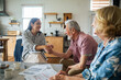 © Marko Geber - Financial advisor meeting senior couple at home