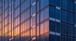 © Toriq - Modern glass skyscraper exterior with reflective windows and geometric design