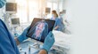 © Chanoknan - Medical professional utilizing tablet-based digital anatomy visualization in high-tech hospital environment to enhance patient diagnostics, monitoring, and clinical workflow optimization.