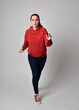 © faestock - full length figure of female model wearing  basic contemporary casual clothing, red hoodie jumper, skinny jeans, sneakers. walking action pose, isolated white studio background.