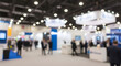 © Ahsanul - Crowd of people walking through a busy exhibition trade show hall with booths