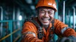 © Freshpixel - This uplifting image features a smiling worker wearing a helmet and safety gear, exemplifying professionalism and joy in the industrious environment, symbolizing hard work and dedication.