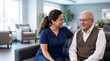 © The Stock Hub - Happy Hispanic Nurse Laughing with Senior Man on Sofa in Assisted Living Home