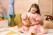 © New Africa - Little girl with cute Easter bunny indoors