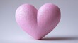 © mila103 - Pink heart shaped object with glittery texture against gray background.