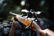 © Ifti Digital - Hunting rifle resting on a log after firing during a morning hunt in the forest, showcasing craftsmanship and the aftermath of a successful shot