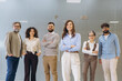 © anatoliycherkas - Diverse business team of professionals standing together at office, collaborating and showing unity