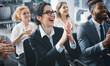 © Prostock-studio - Perfect business lecture. Happy entrepreneurs applauding at conference, listening speaker's speech
