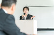© buritora - Businesswoman giving a presentation at a meeting, training session, or presentation