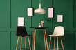© Pixel-Shot - Interior of modern stylish room with chairs and table near green wall
