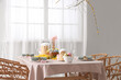 © Pixel-Shot - Beautiful table setting for Easter cakes and eggs in dining room