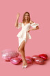 © Pixel-Shot - Beautiful young woman with heart-shaped balloons on pink background. Valentine's Day celebration