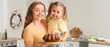 © Pixel-Shot - Happy mother and her cute daughter with freshly baked Easter cake in kitchen
