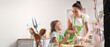 © Pixel-Shot - Little girl with her mother preparing Easter cake in kitchen