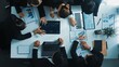 © InfiniteFlow - Top view of smart business people brainstorm marketing idea at meeting table while compare stock market investment data between laptop and tablet. Business team planning financial plan. Directorate.