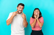 © luismolinero - Young couple isolated on blue background smiling with a happy and pleasant expression