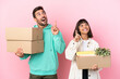 © luismolinero - young beauty couple moving in new home among boxes isolated on pink background pointing with the index finger a great idea