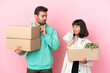 © luismolinero - young beauty couple moving in new home among boxes isolated on pink background having doubts while scratching head