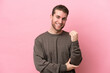 © luismolinero - Young caucasian man isolated on pink background laughing