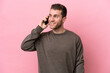 © luismolinero - Young caucasian man isolated on pink background keeping a conversation with the mobile phone