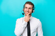 © luismolinero - Telemarketer caucasian man working with a headset isolated on blue background thinking an idea while looking up