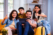 © StockImageFactory - Indian parents and kids enjoying digital screen time together on tablet while relaxing at home