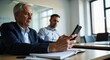 © Michael - 'Men working in a meeting room using digital devices'