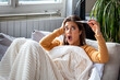 © Graphicroyalty - Shocked Woman checking High Temperature on Thermometer. Sick girl with Fever and Flu, Healthcare and Medicine concept. Attractive woman wrapped in blanket looking surprised at medical device.