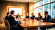 © Rahman - Blurred blurred image of a business meeting with diverse professionals seated around a conference table in a modern office setting with large windows and natural light