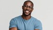 © mila103 - Confident african male adult smiling in glasses and casual attire.