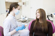 © Victoria - A dentist shows a woman how to brush her teeth