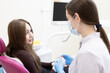 © Victoria - The patient is afraid of the dentist and covers her mouth with her hands. woman sitting in dental chair
