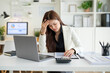 © wattana - Female financial professional concentrating on complex accounting data at her desk.